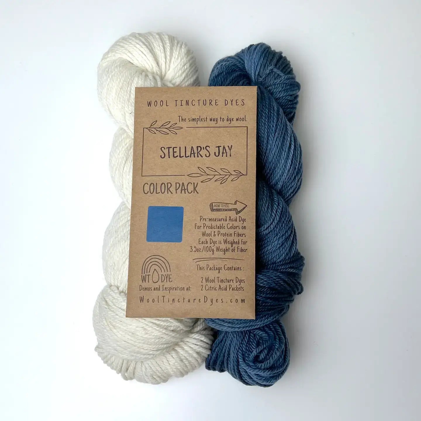 Stellar’s Jay Wool Tincture tea bag dye color pack with undyed yarn and deep blue sample color.
