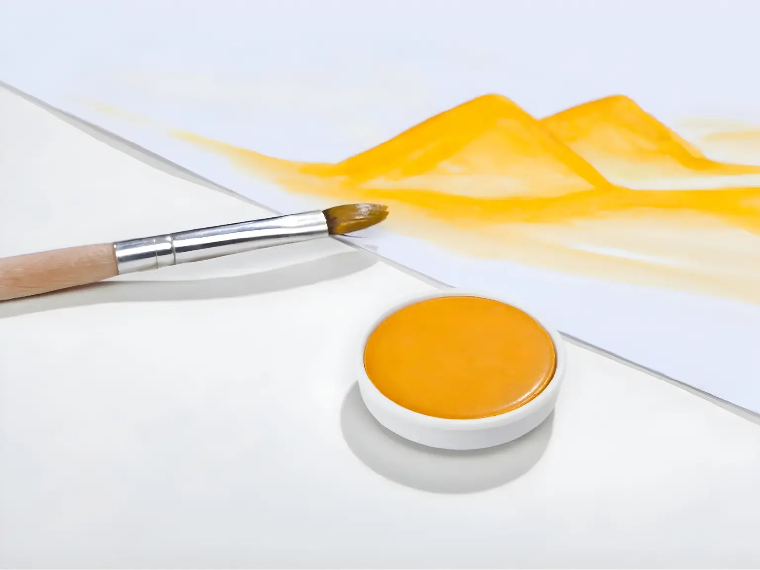 Golden Yellow Stockmar opaque paint with a brush on a white background