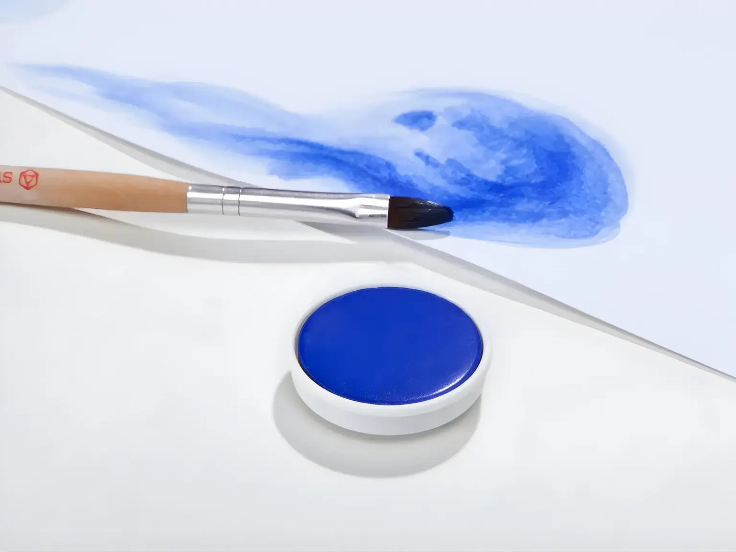 Ultramarine Stockmar opaque paint with a brush on a white background