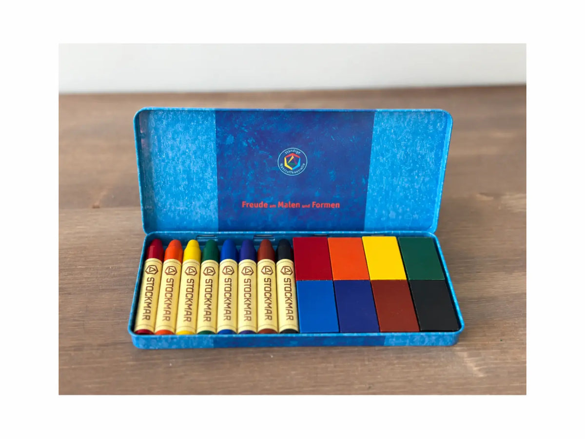 Stockmar Standard 8 color beeswax crayons and wax blocks arranged in an open blue tin