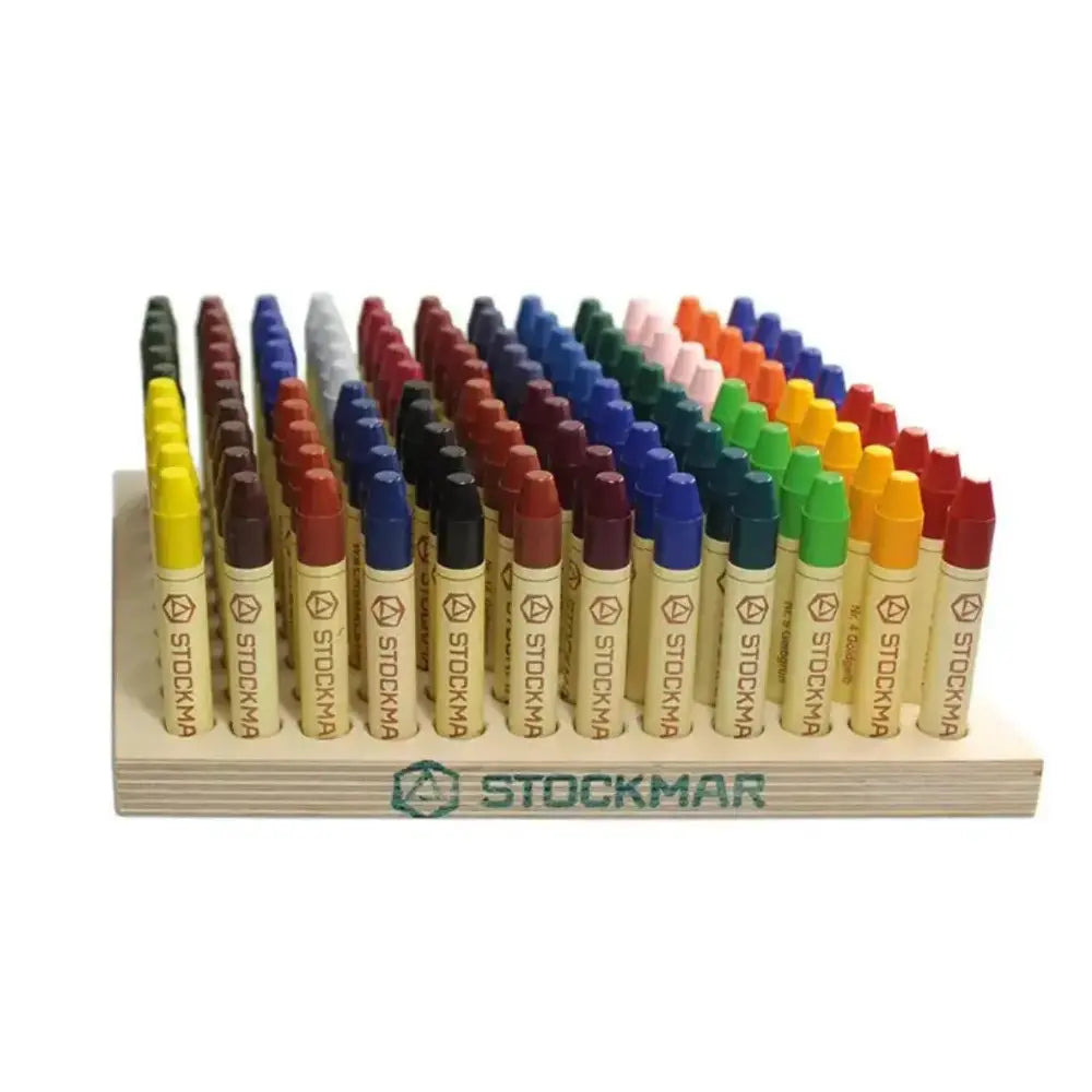 Set of Stockmar crayons on a wooden holder with a white background