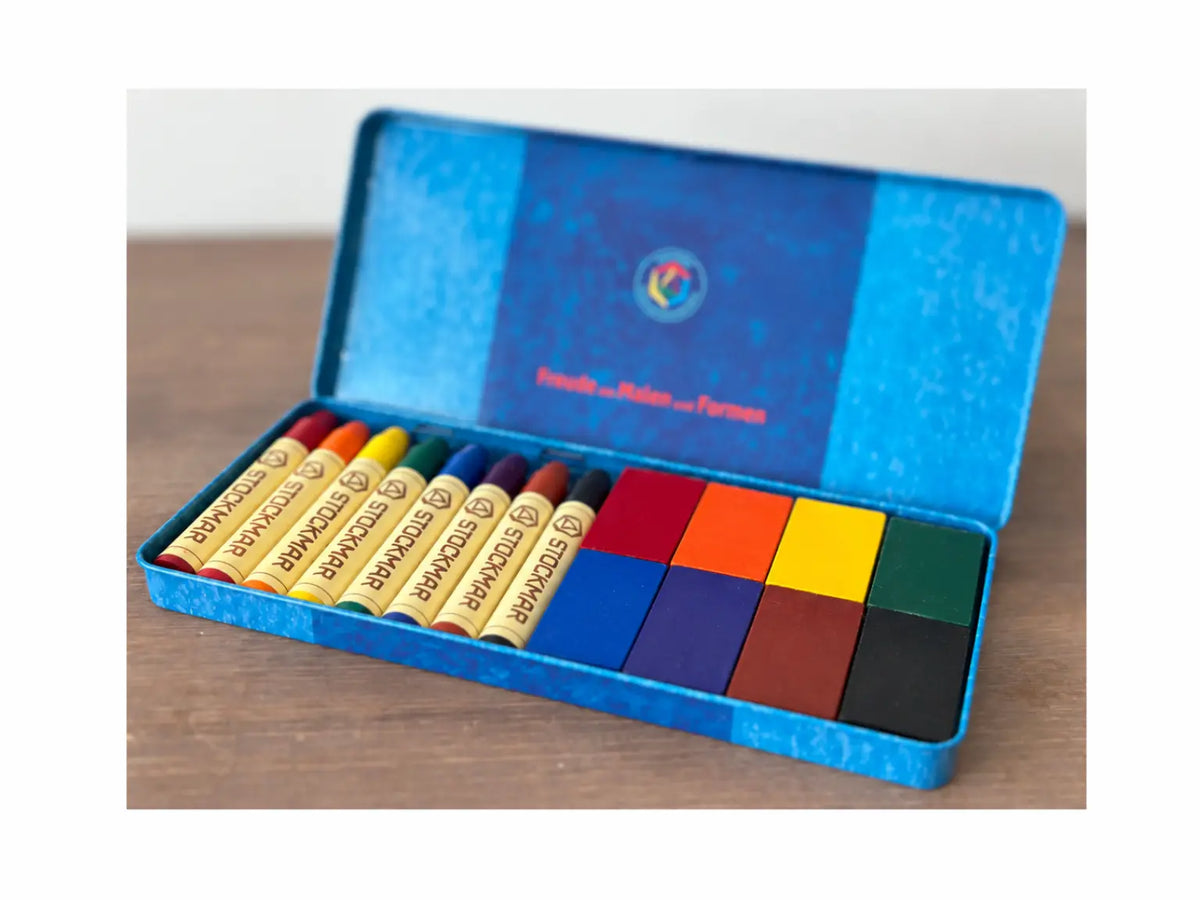 Stockmar Standard 8 color beeswax crayons and wax blocks arranged in an open blue tin