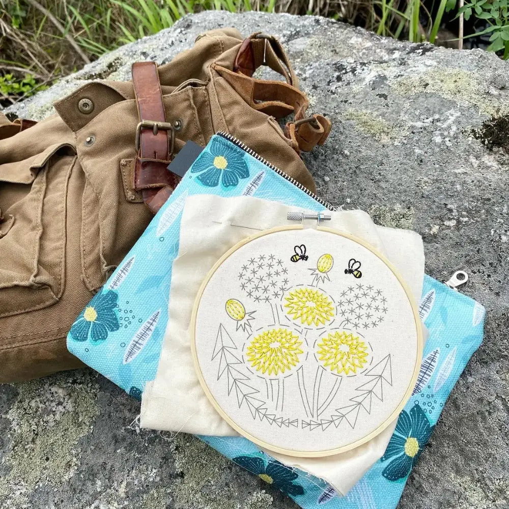 Bee Kind dandelion embroidery kit packed with fabric project bag outdoors