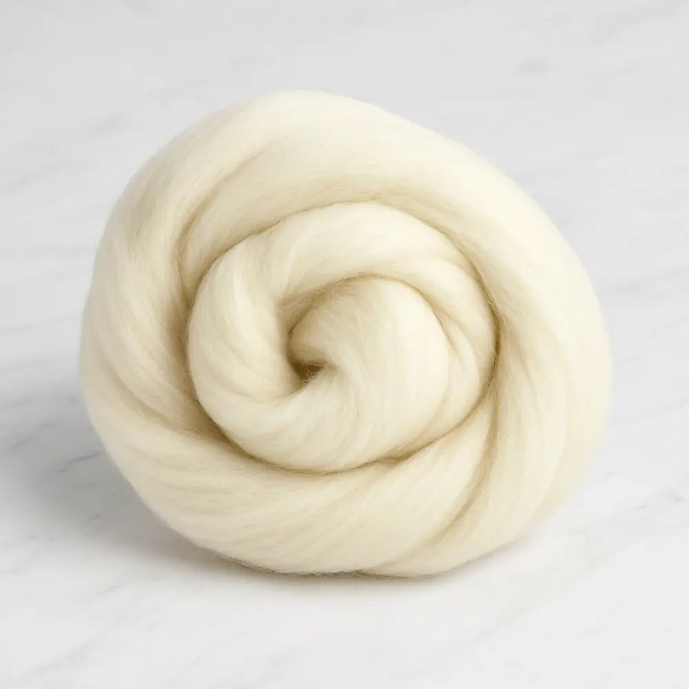Coiled beige targhee wool on a white background
