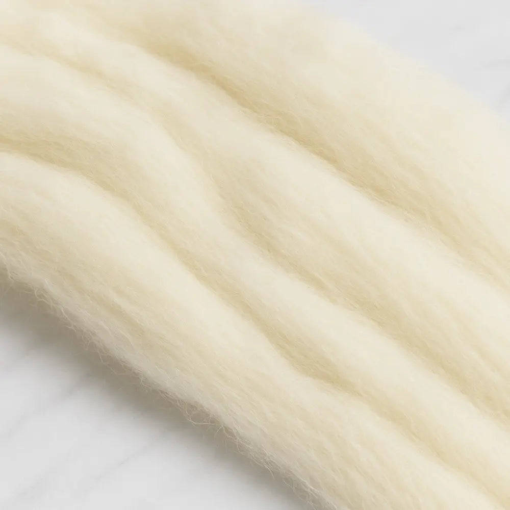 Close-up of light beige hair extensions on a white background