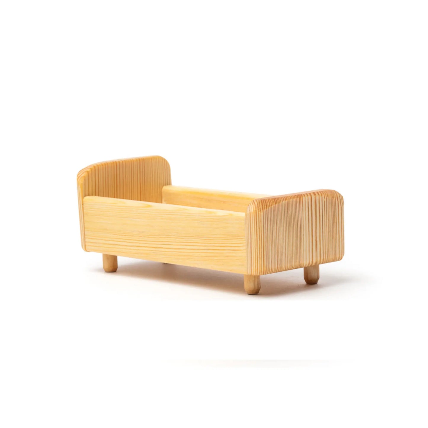 Wooden dollhouse bed on a white background