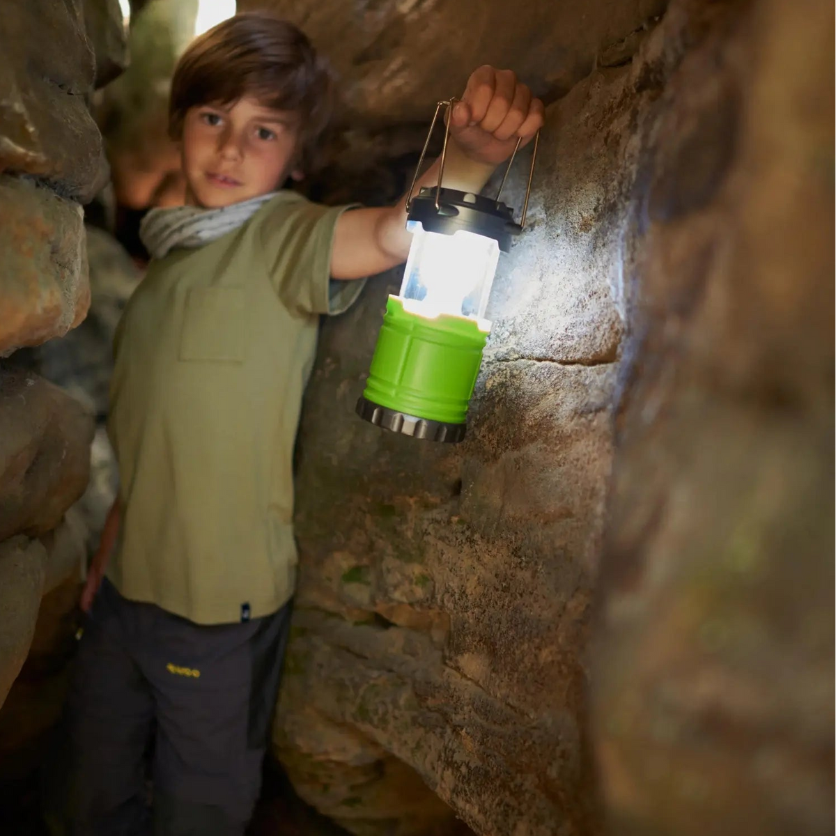 Child exploring with the illuminated HABA Terra Kids Camping Lantern