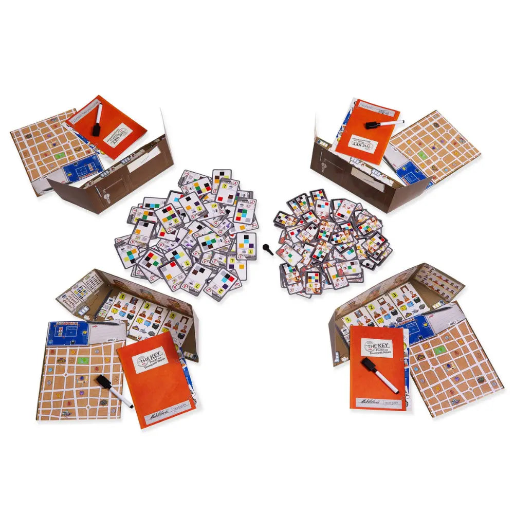 The Key Escape from Strongwall Prison game components with cards, tiles, and key mechanism laid out