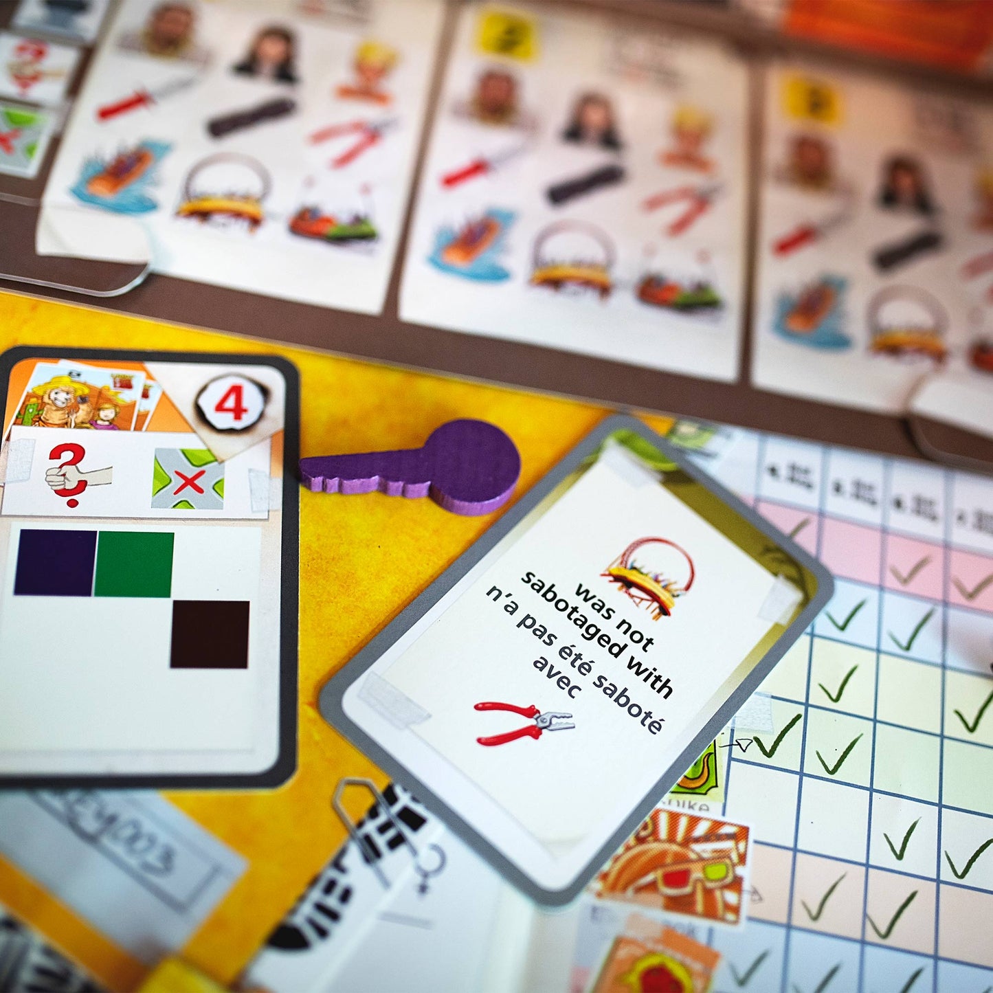 Board game cards and pieces on a yellow surface with a focus on communication and strategy.