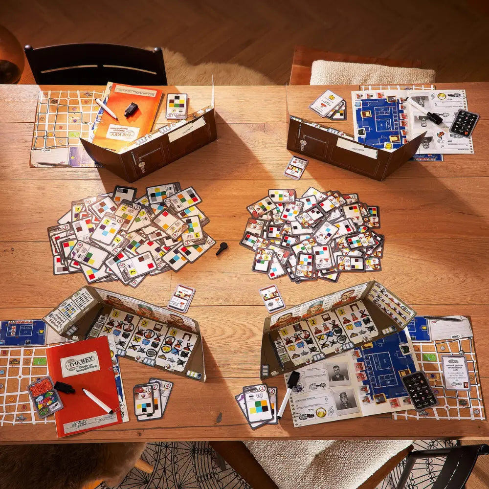 Board game components on a wooden table with scattered cards and pieces.