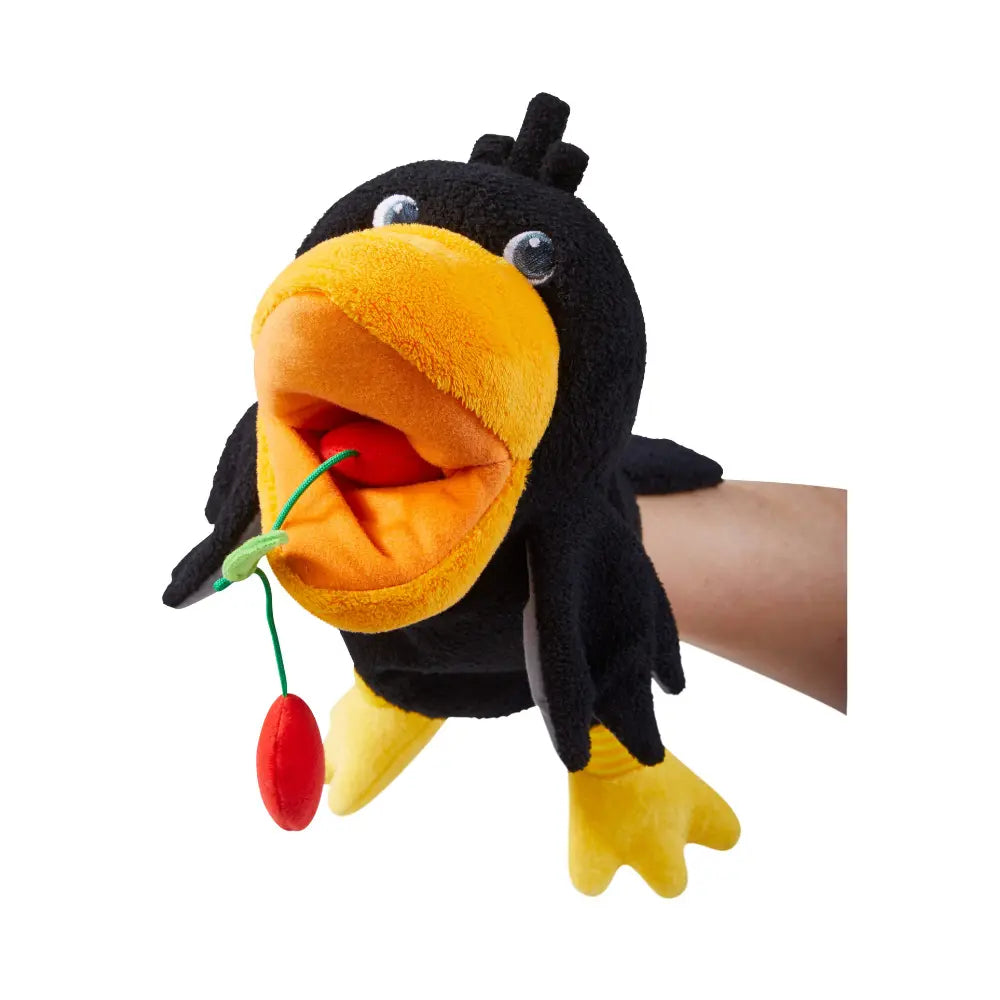 Close-up of Theo the Raven puppet with movable beak holding fabric cherries
