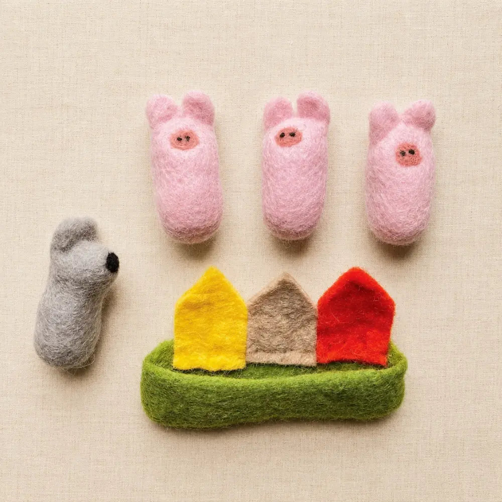Three Little Pigs felt play set pieces arranged separately with three pigs, wolf, houses, and green felt pouch.