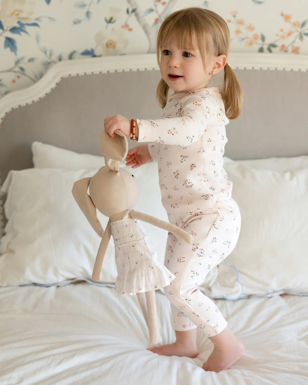 Toddler holding soft bunny doll as comfort toy and play companion