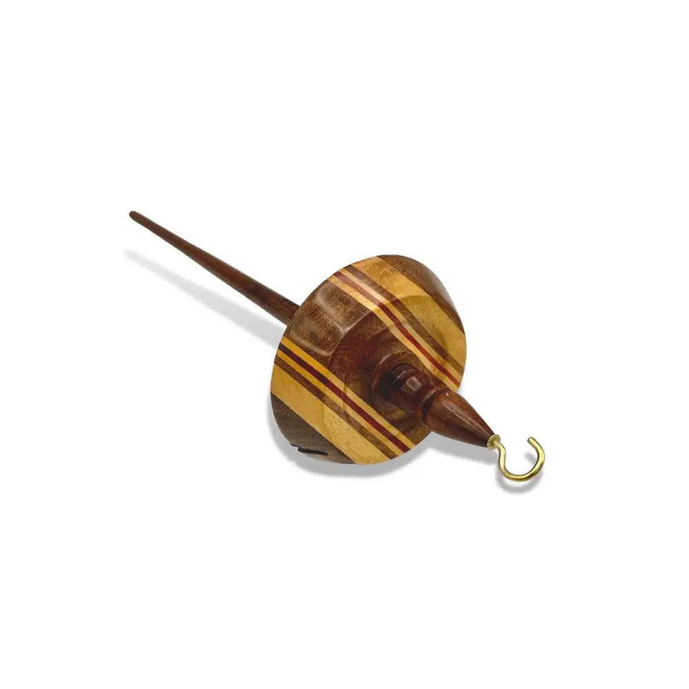 Wooden top whorl drop spindle with white yarn on a white background