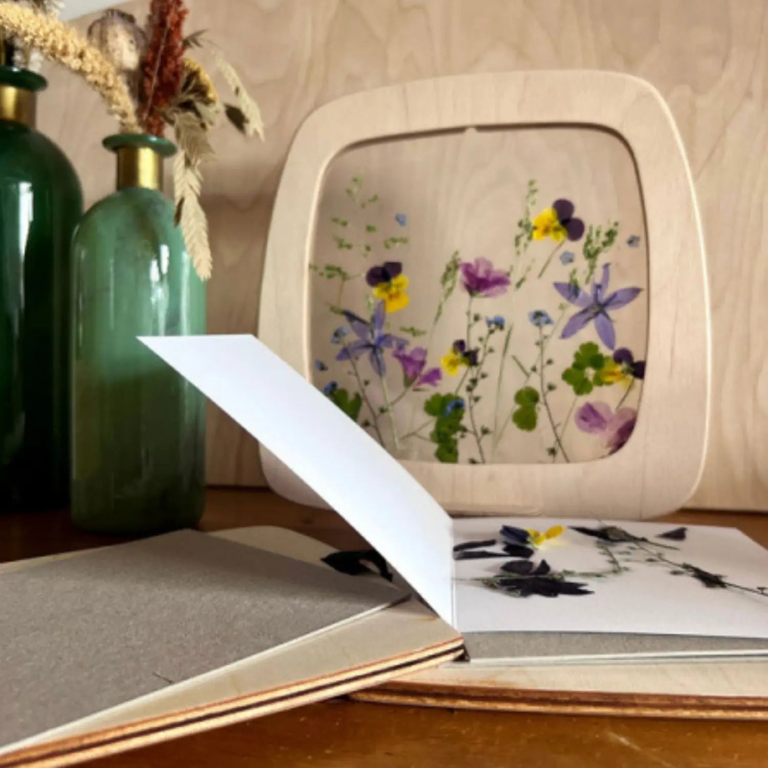 Pressed flowers displayed in a Toverlux Lamp beside the Toverlux Flower Press