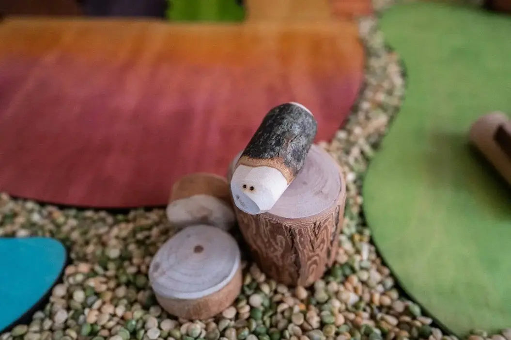 Tree Creatures wooden figures in a colorful small-world play scene with natural materials