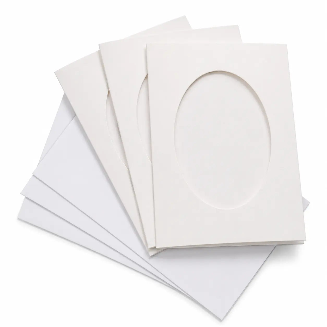 Three white tri-fold encaustic window cards with oval openings and matching envelopes