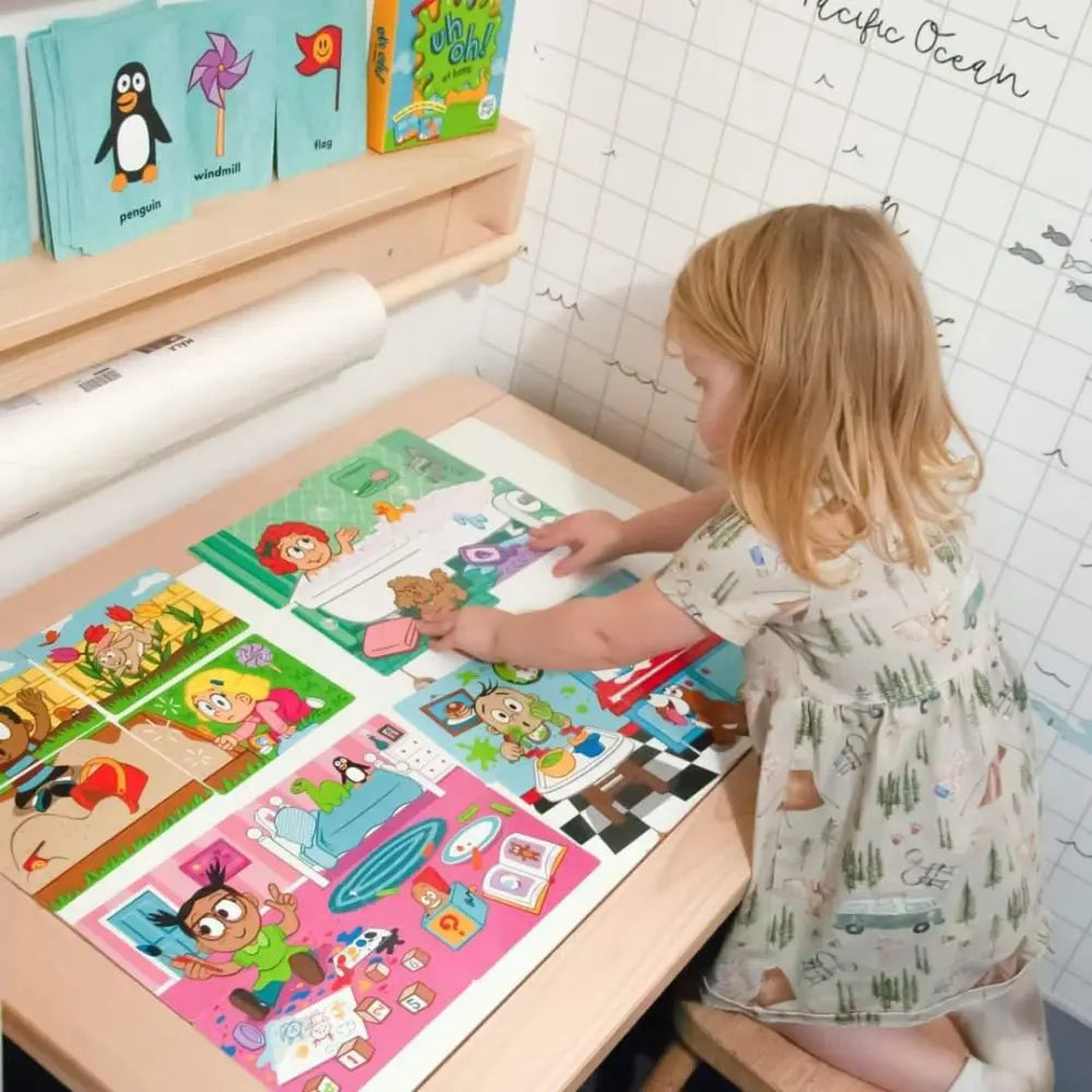 Child playing with educational puzzles at a table in a room with educational posters on the wall.