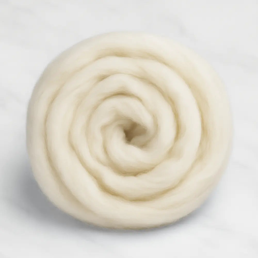 Rolled-up ball of white yarn on a light gray background