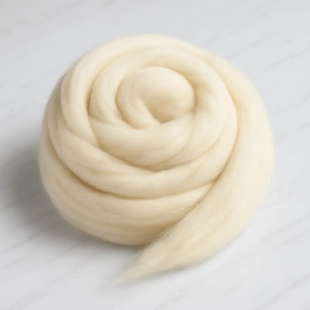 Ball of beige wool on a light gray background