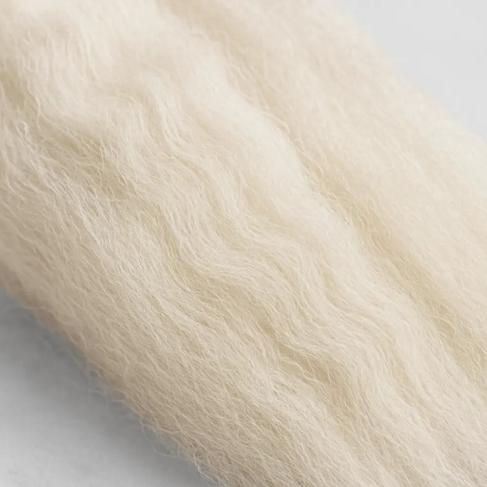 Close-up of light beige fur texture on a white background