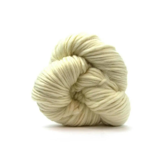 Cream-colored skein of undyed merino super bulky yarn on a white background