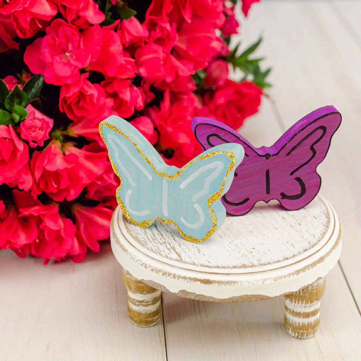Decorated wooden butterflies shown as inspiration for spring and summer seasonal craft projects
