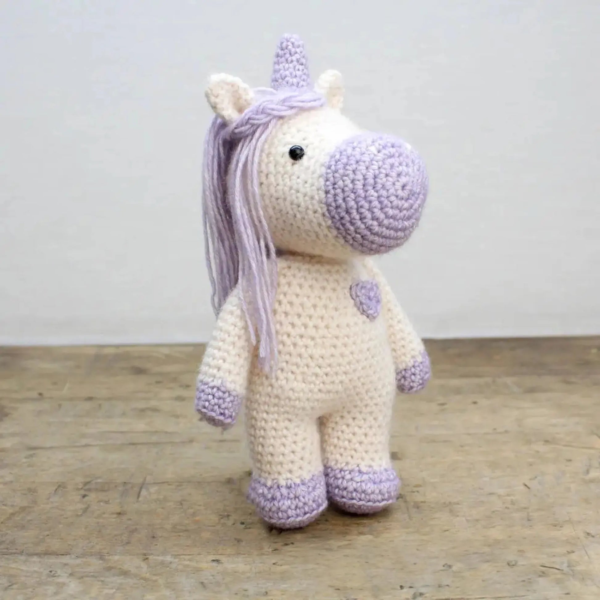 Finished handmade crocheted unicorn stuffed animal from a DIY crochet kit