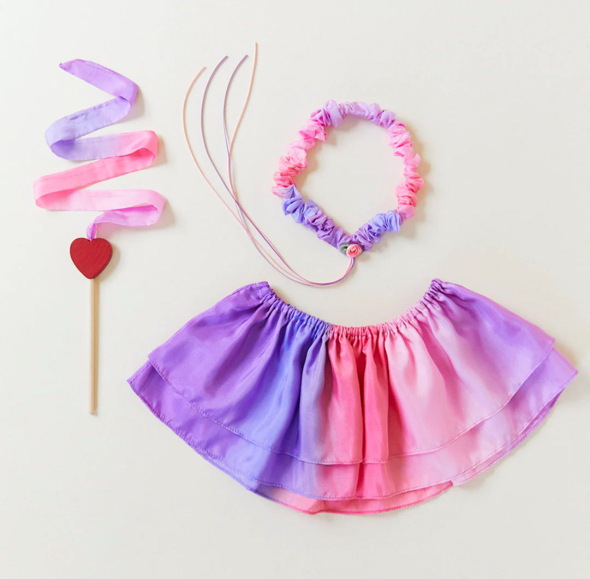 Blossom colorway silk streamer want, garland, and tutu on a light background