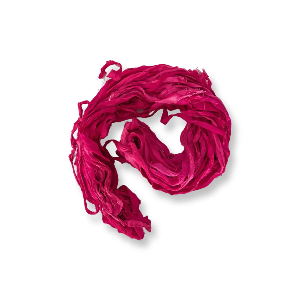 Loosely coiled hank of berry-pink recycled sari silk chiffon ribbon yarn, Very Berry Purples colorway