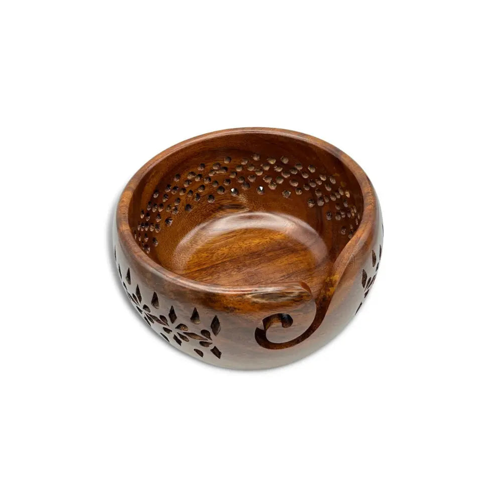 Wooden incense holder with intricate carvings on a white background