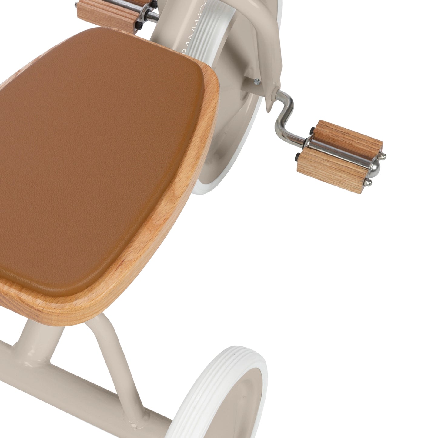 Close-up of a brown vegan leather on wooden seat and wooden pedals on a tricycle on a white background