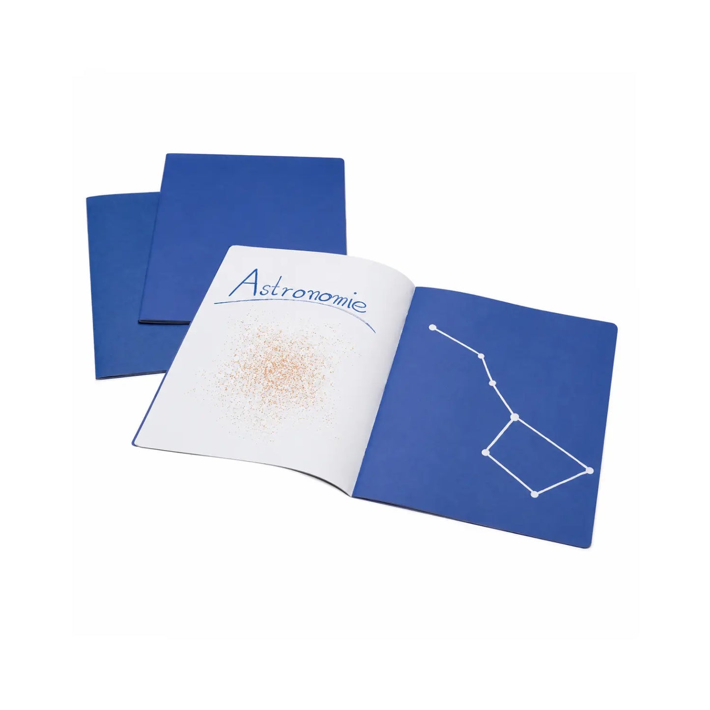 Astronomy main lesson book with a handwritten astronomy title and constellation drawing beside two blue lesson books