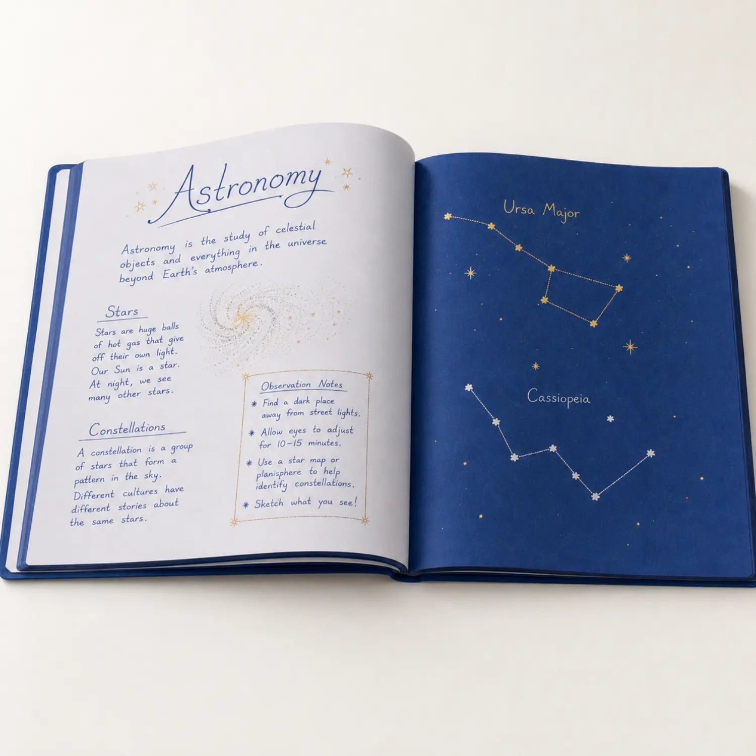 Waldorf astronomy main lesson book with handwritten astronomy notes and gold and silver constellation drawings on blue paper