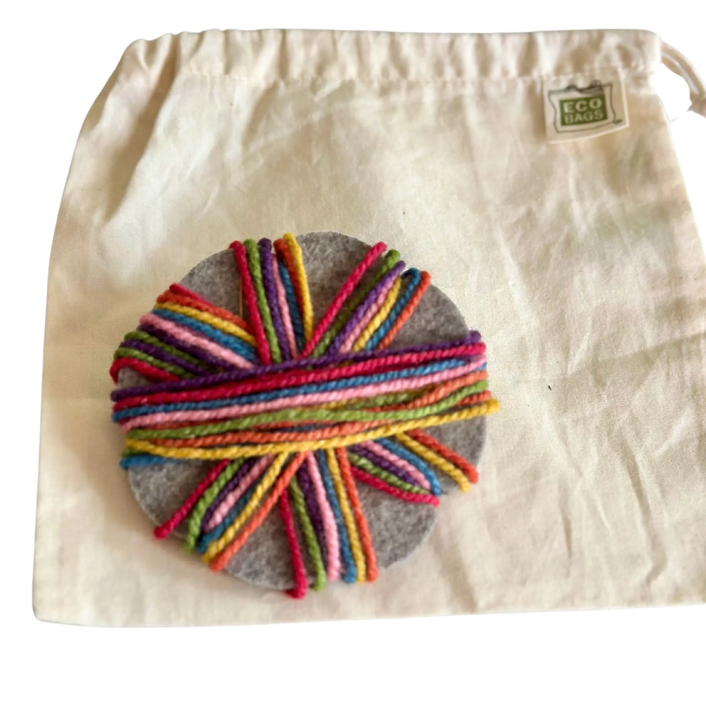 Wool Felt Kumihimo Braiding Star  with rainbow yarn on a cotton drawstring bag