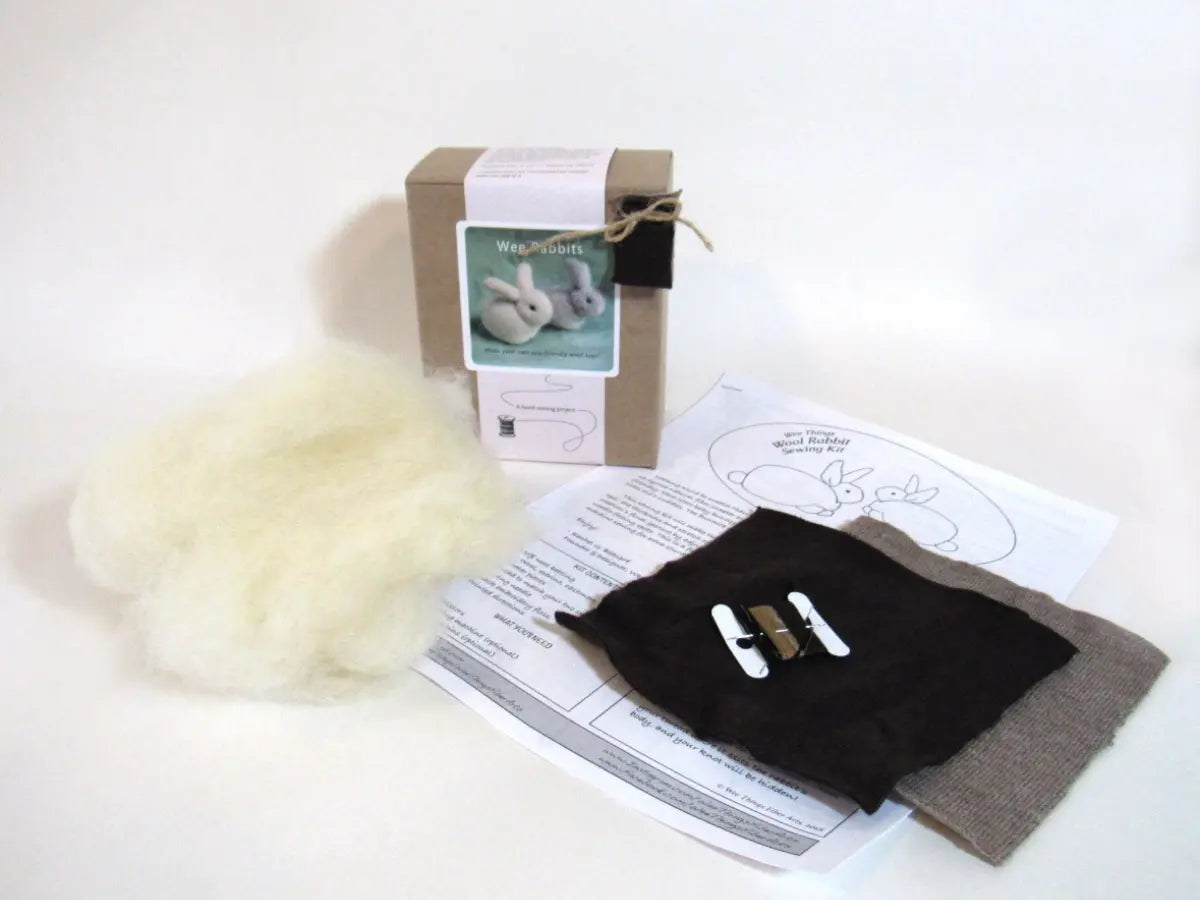 Crafting kit with fabric, batting, and instructions on a white background