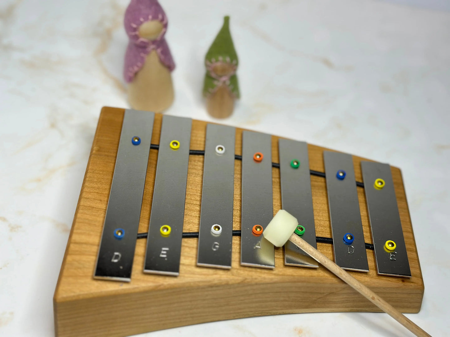 Wooden xylophone with metal bars on a light background