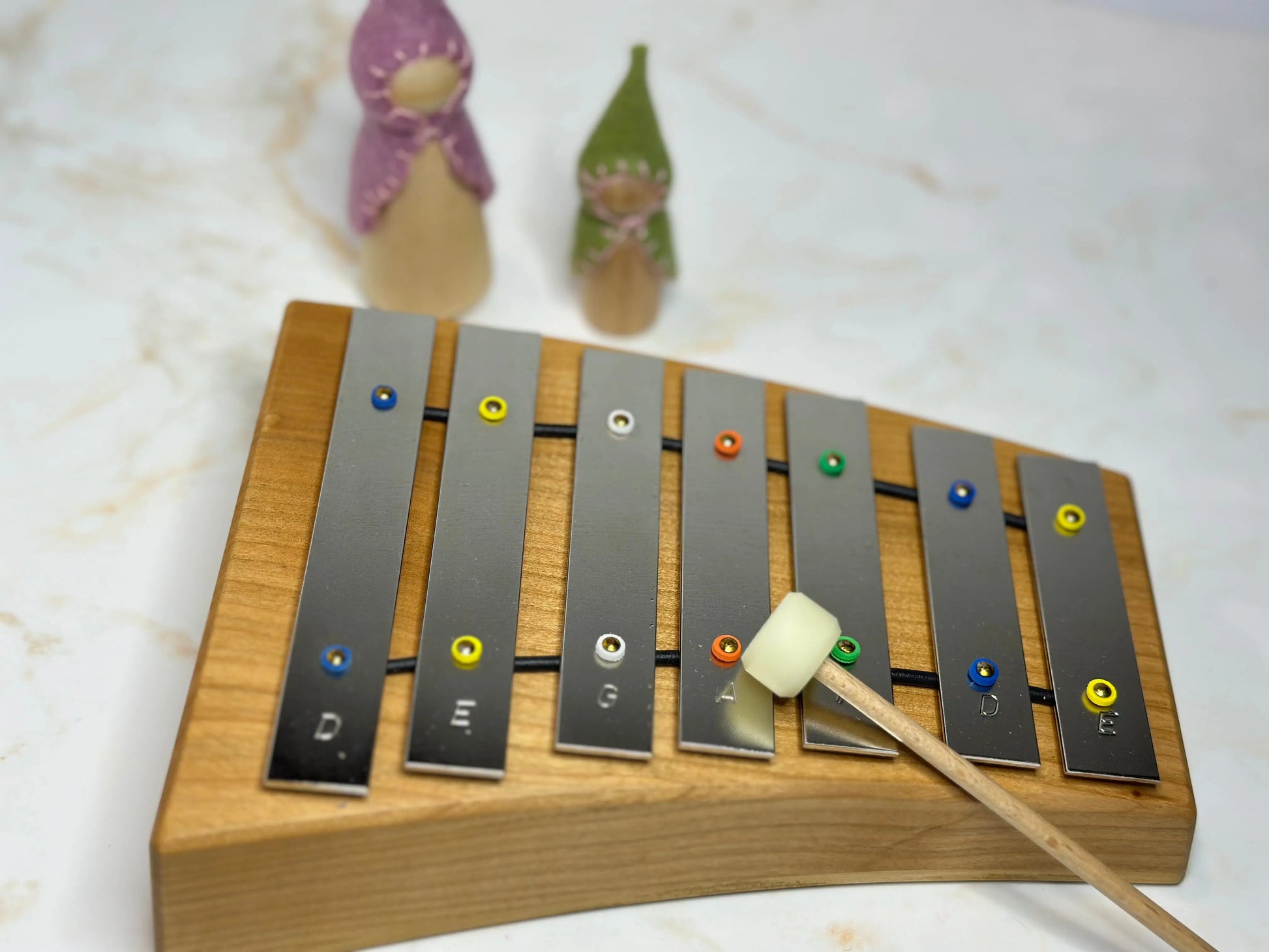 Wooden xylophone with metal bars on a light background