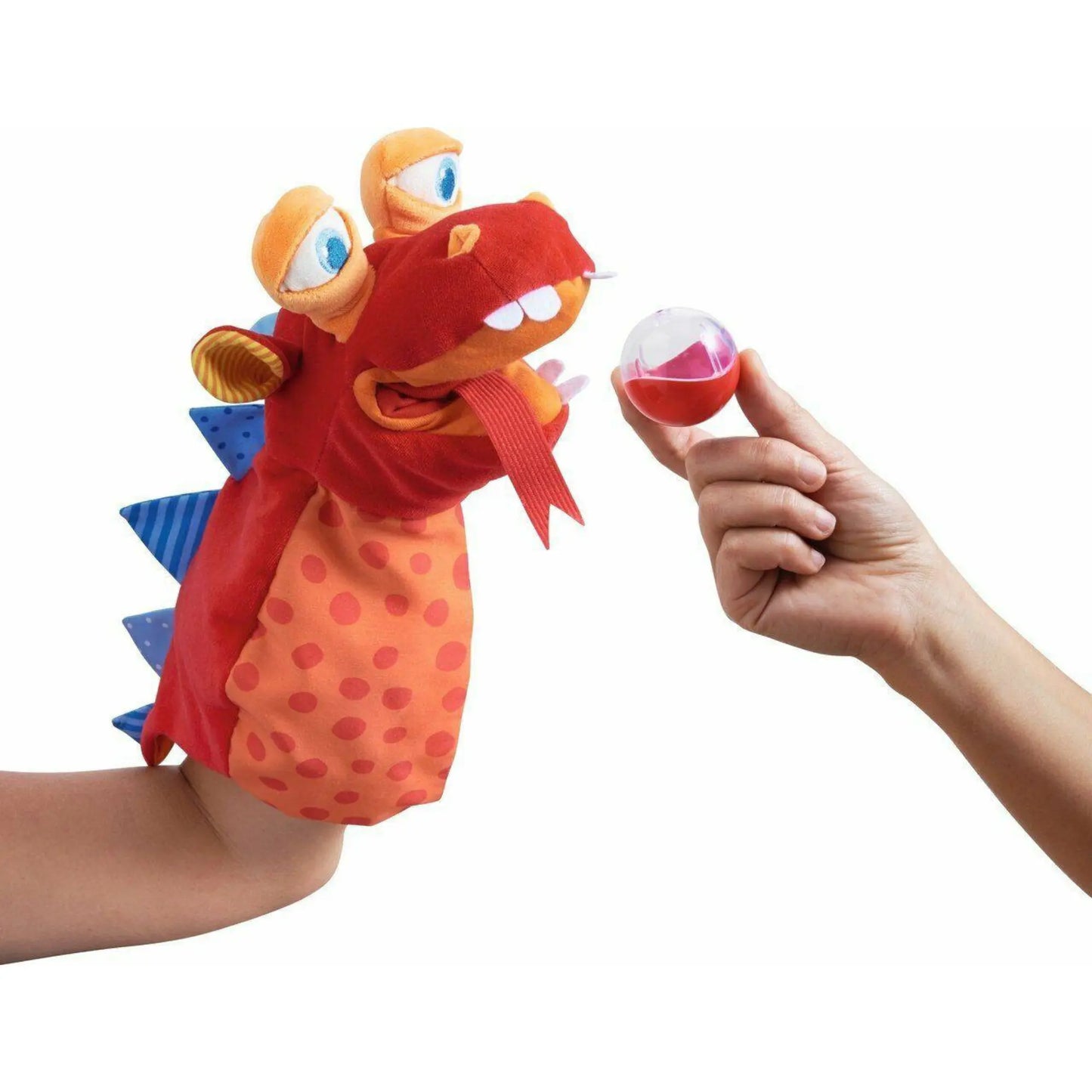 Colorful dragon-shaped glove puppet with a hand holding a small ball against a white background