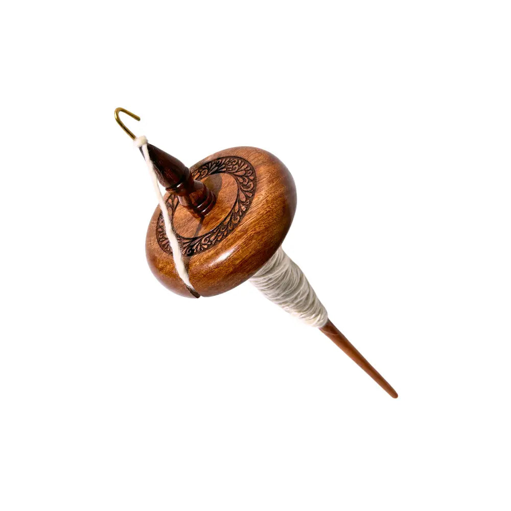 Wooden top whorl drop spindle with white yarn on a white background