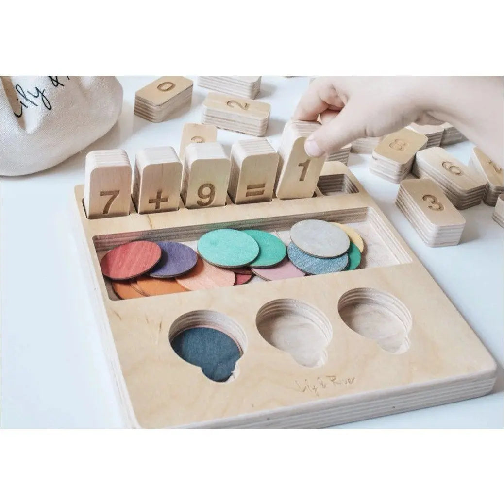 Wooden educational toy with number blocks and color discs on a white surface