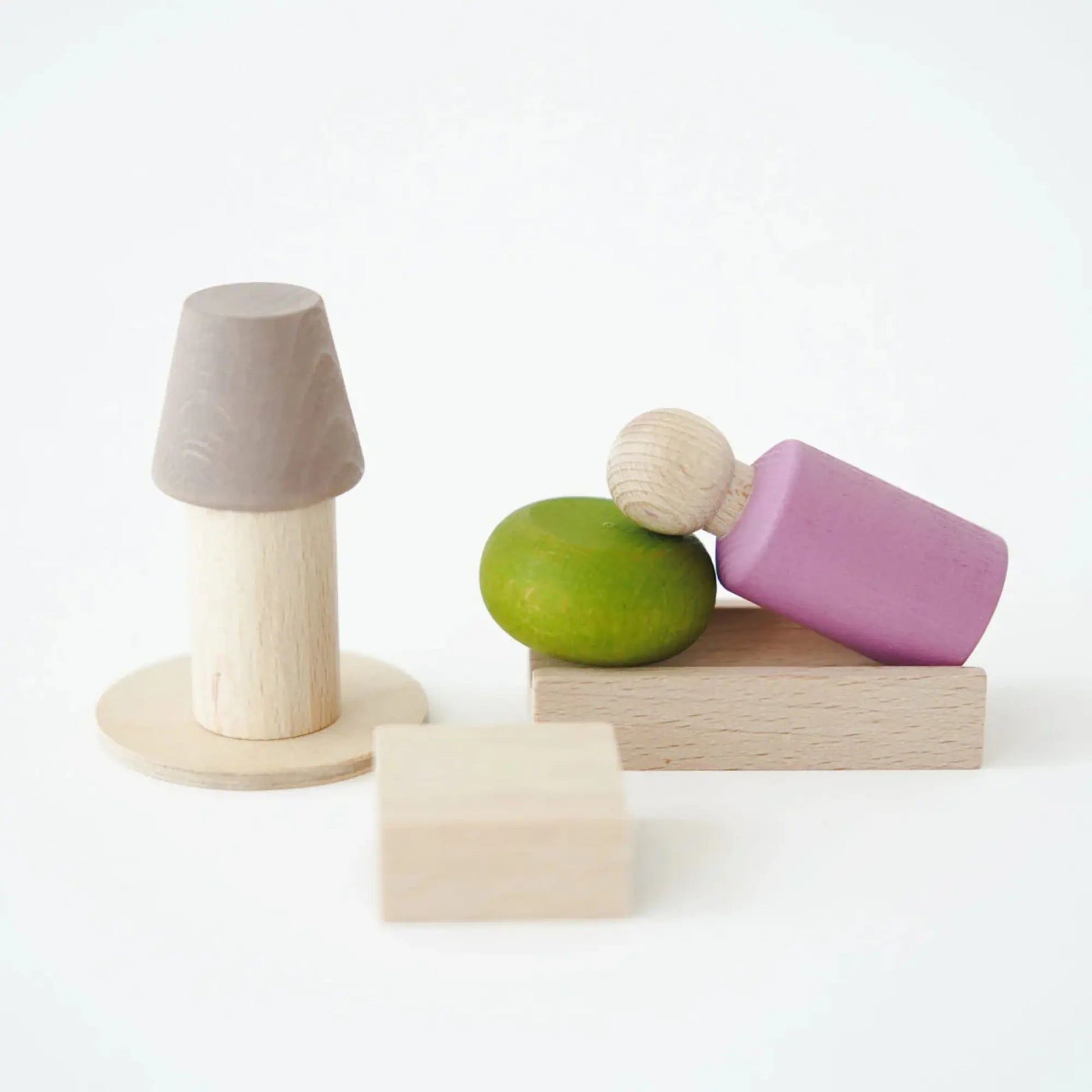 Set of colorful wooden blocks pink peg doll on a white background