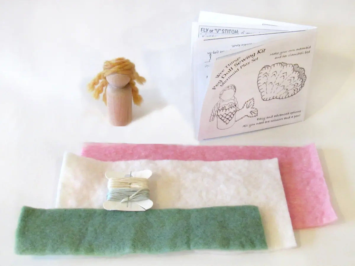 Felt mermaid peg doll kit with materials and instructions on a white background