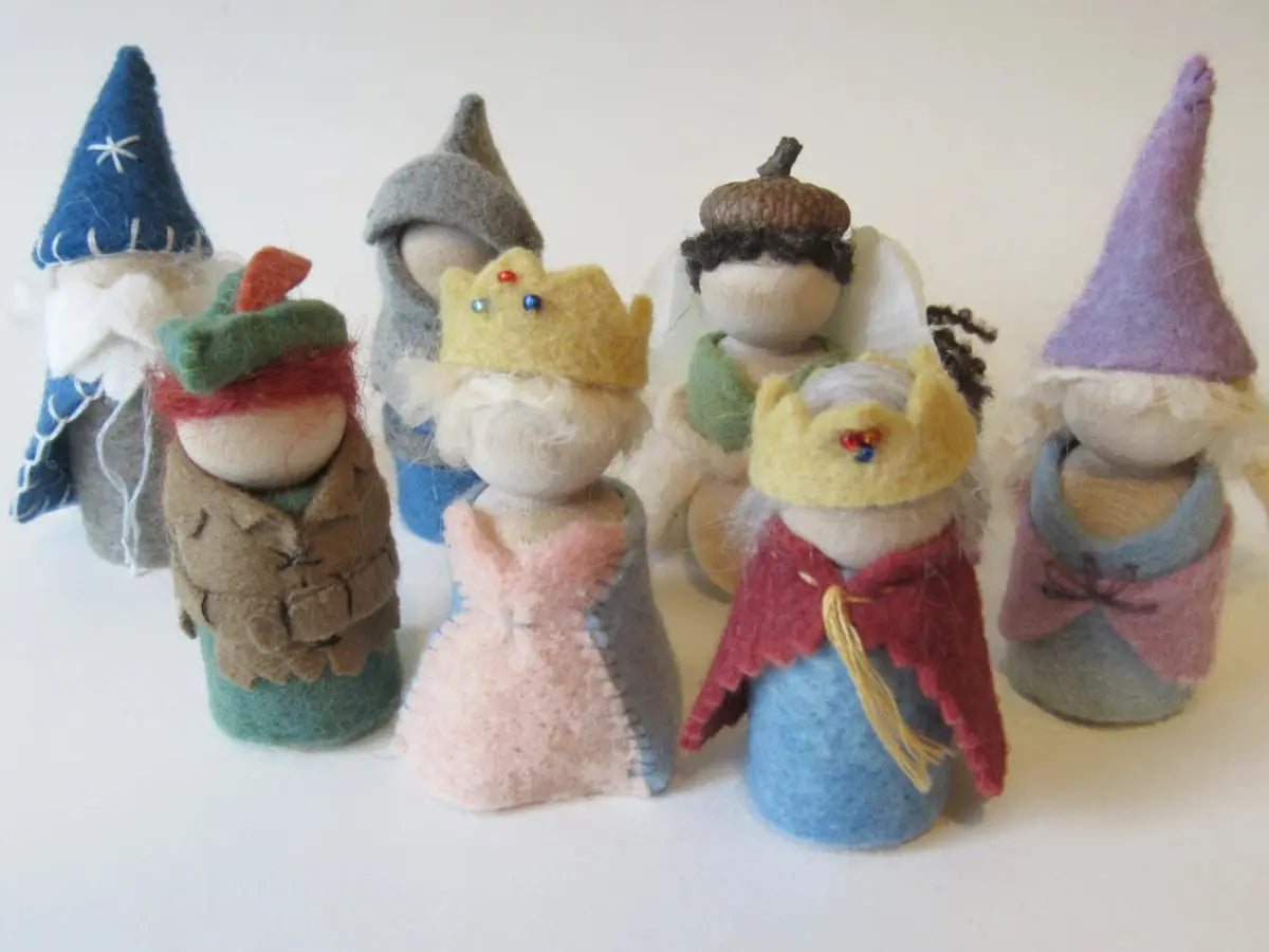 Set of colorful felted dolls with various accessories on a white background