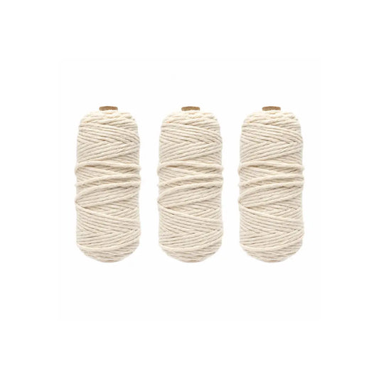 Three skeins of cotton warp string for looms on a white background