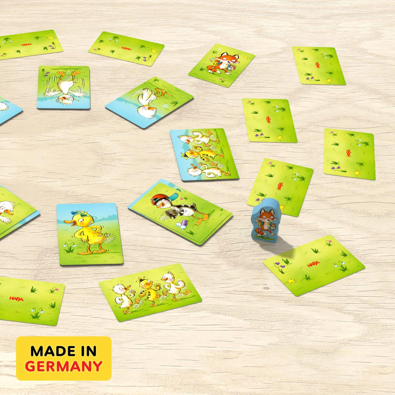 Cards showing ducks a a wooden fox fanned out on a table with text Made in Germany
