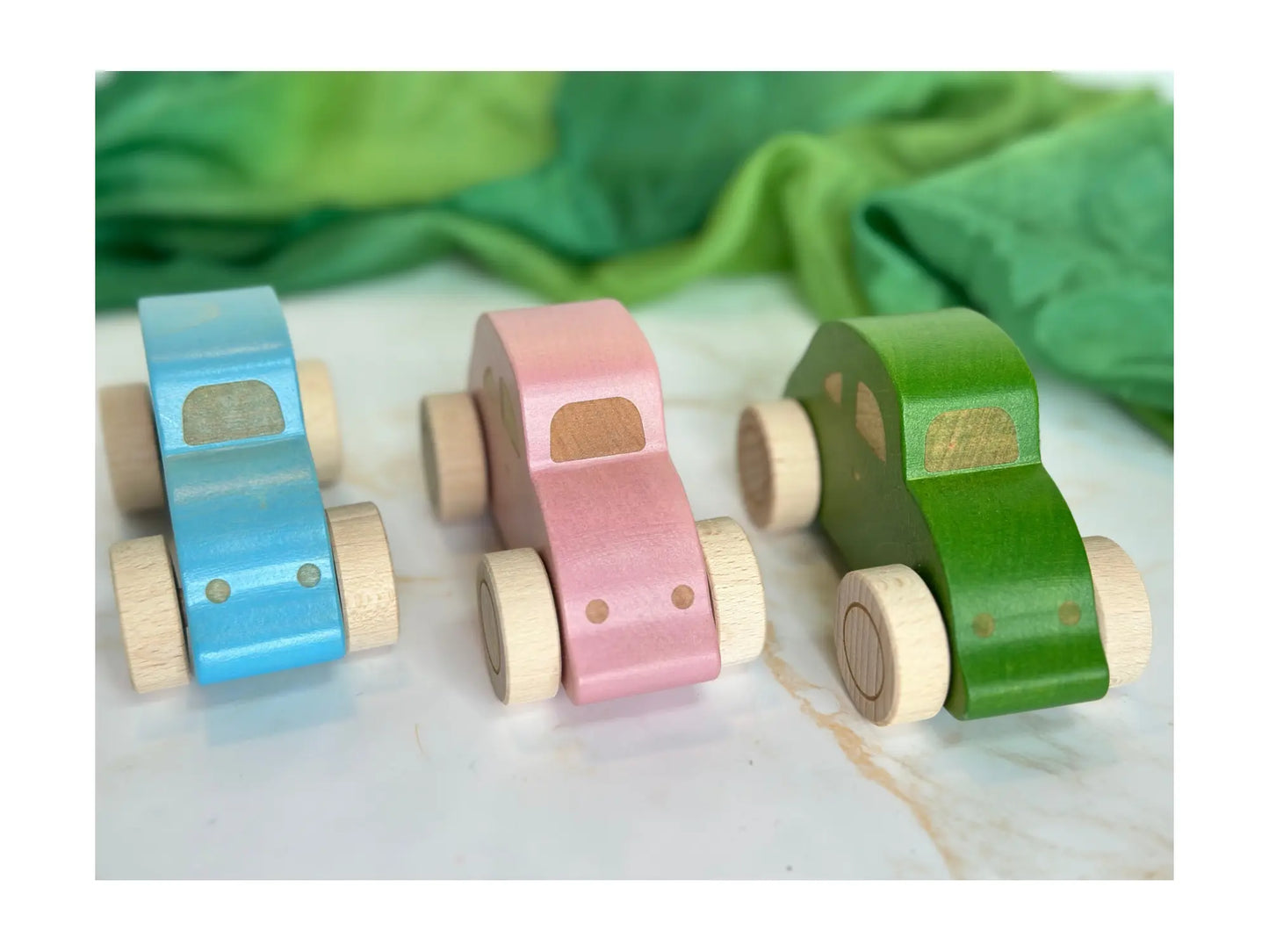 Handmade wooden beetle cars with front view in three colors blue, pink, and green