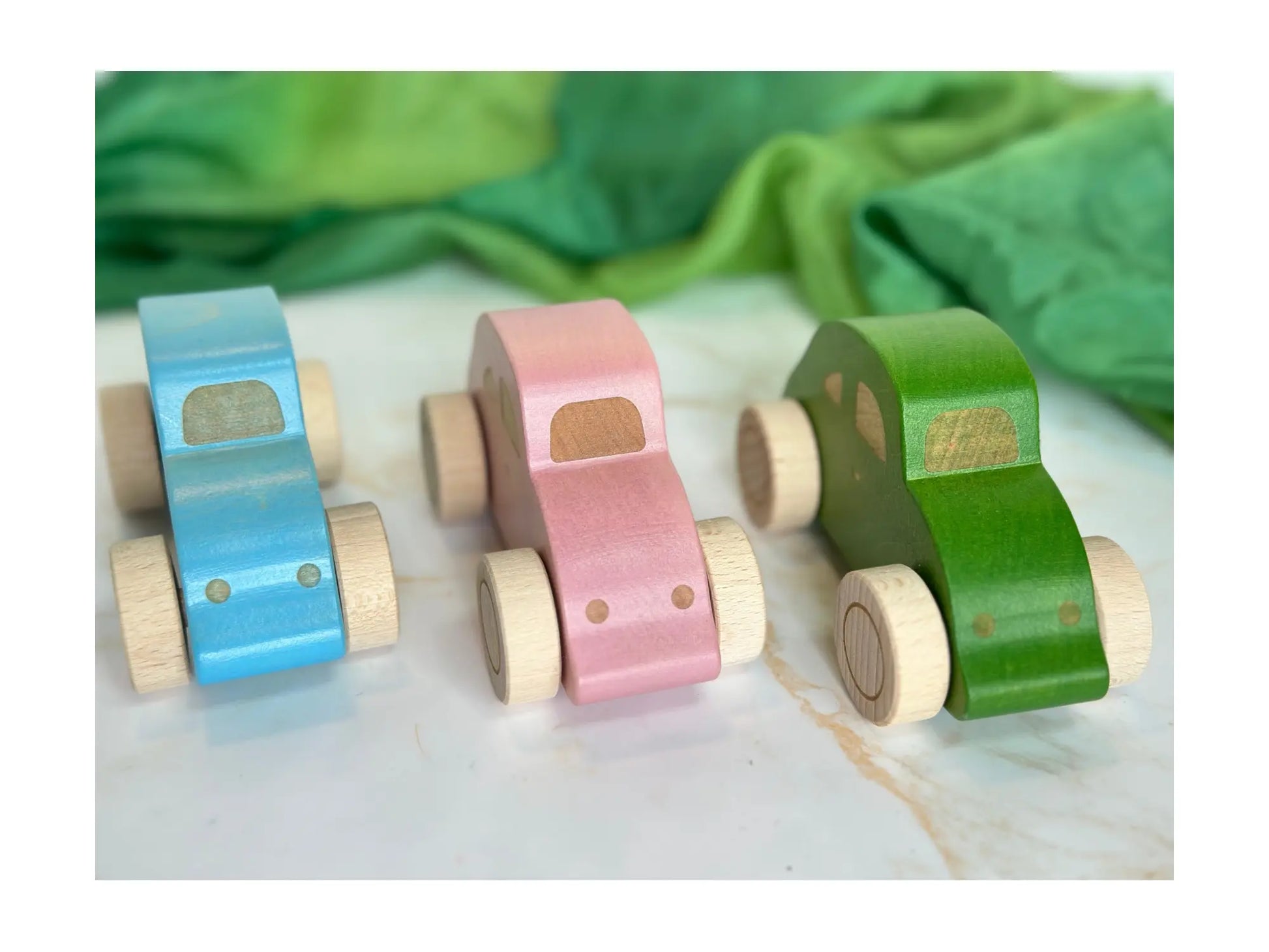Handmade wooden beetle cars with front view in three colors blue, pink, and green