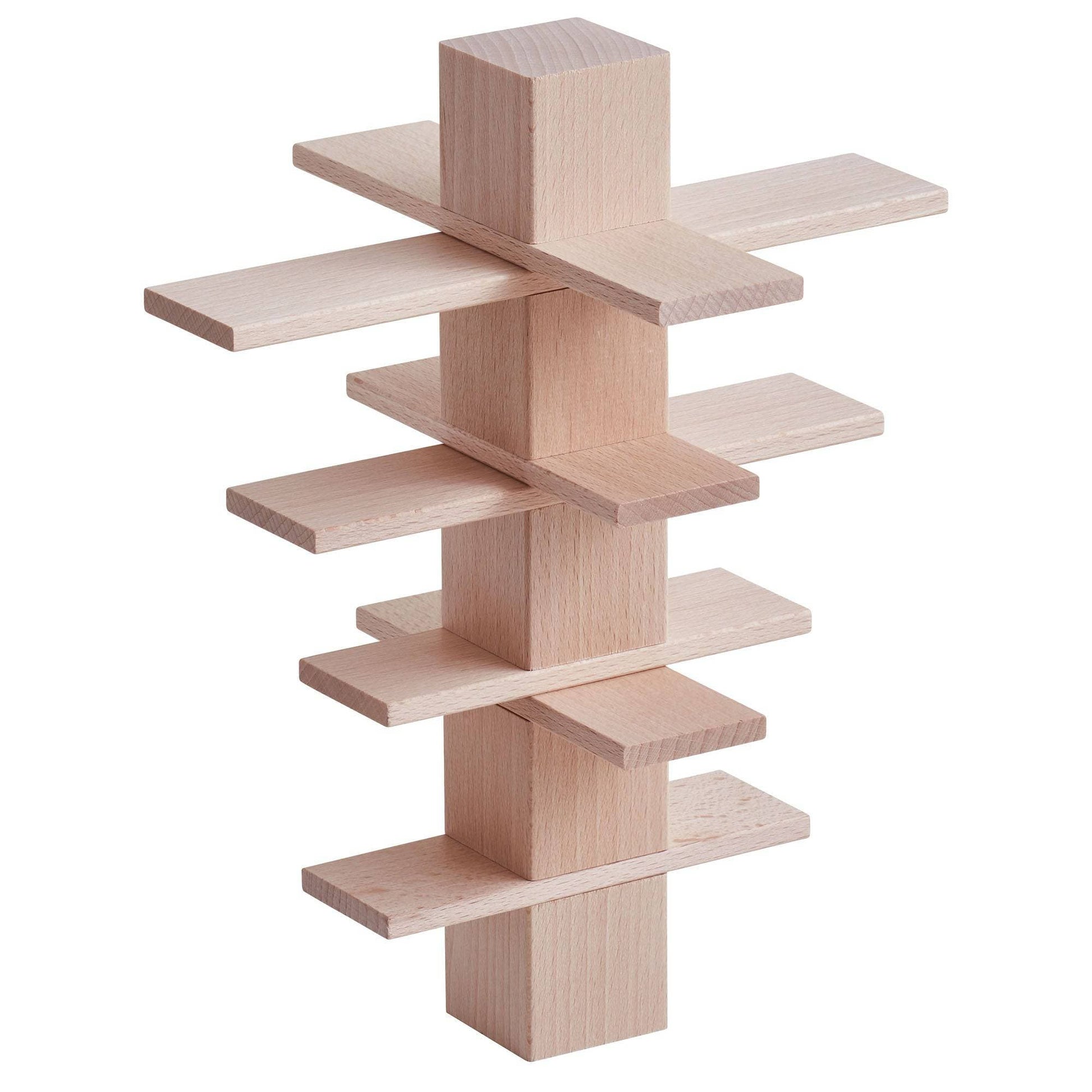 Tall vertical tower made from stacked wooden building blocks and flat panels