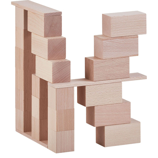Wooden building blocks arranged into a bridge structure using natural beechwood cubes and panels